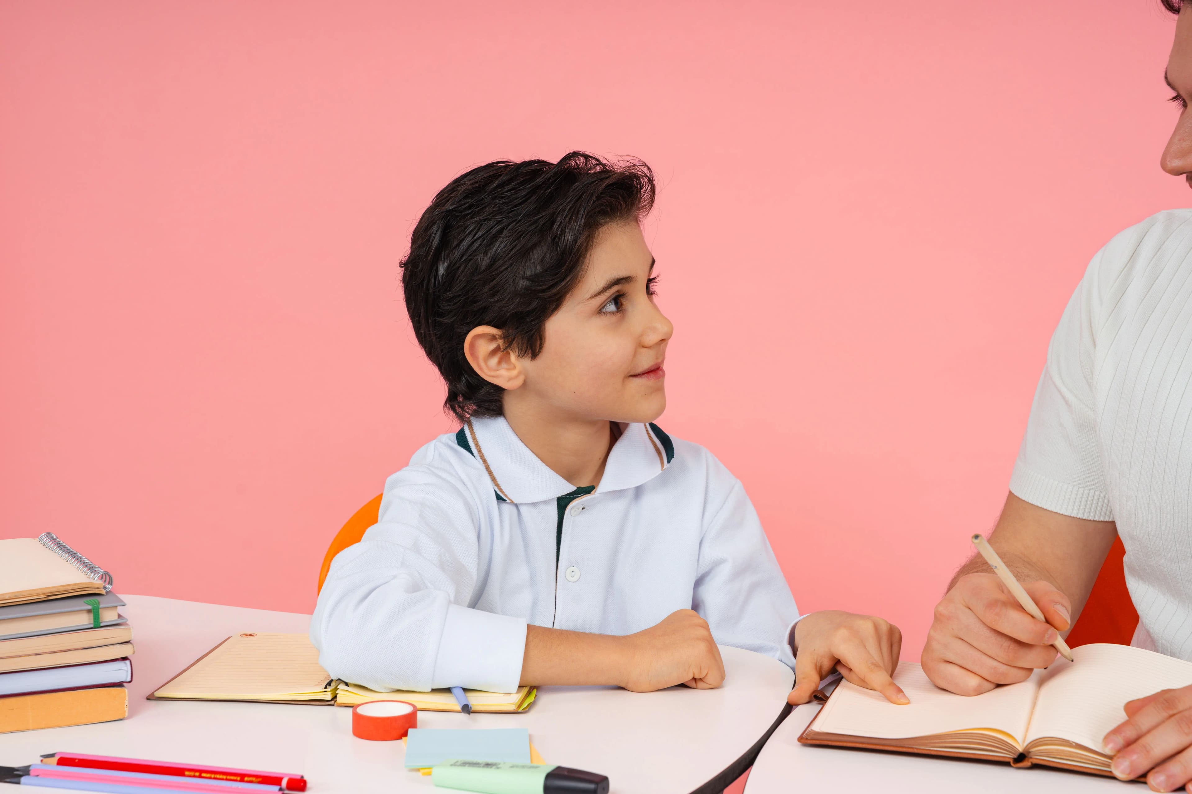 Teacher reviewing written work with a primary-school student